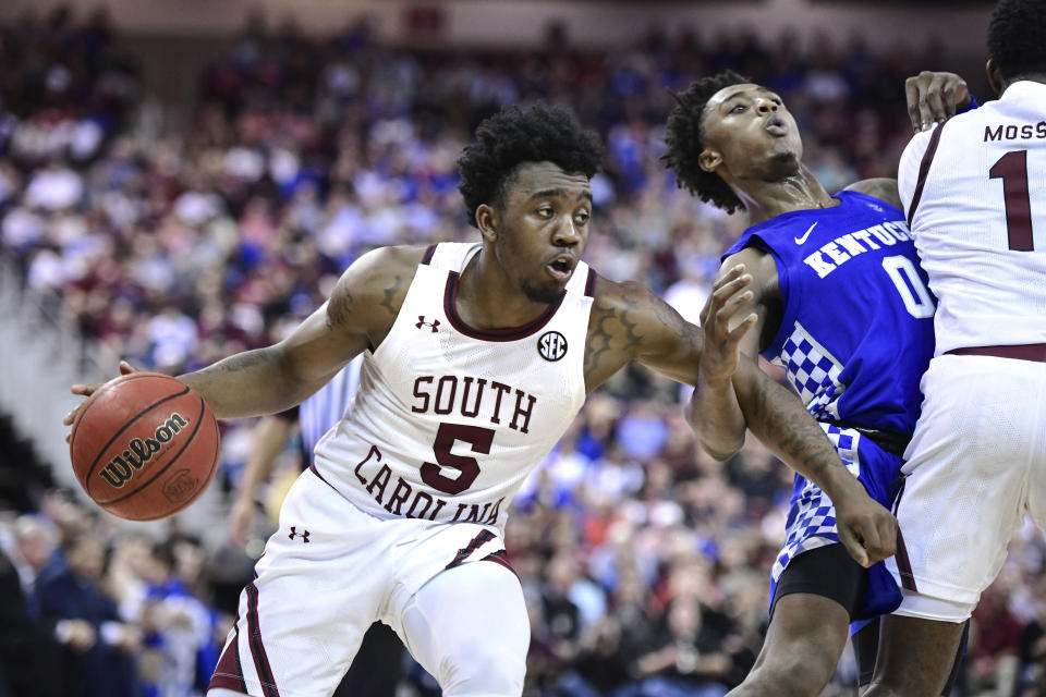 South Carolina guard Jermaine Couisnard (5) dribbles the ball as T.J. Moss (1) sets a screen on Kentucky guard Ashton Hagans (0) during the second half an NCAA college basketball game Wednesday, Jan. 15, 2020, in Columbia, S.C. South Carolina won 81-78. (AP Photo/Sean Rayford)