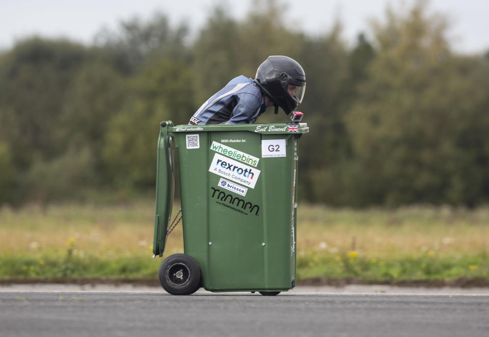 A wacky design engineer is delighted to have set a new Guinness World Record after reaching speeds of over 40mph - in a WHEELIE BIN. Andy Jennings, 28, transformed his green household waste bin into a racing machine - complete with a small motorbike engine, a gear box, ignition, a bike seat, and the steering from a mobility scooter. Andy hit the tarmac in his rigged-out bin to attempt to set his brand new world record. Guinness World Record officials set Andy a benchmark of over 30mph in order to secure the record for fastest wheelie bin. But the engineer, from Swindon, Wilts., smashed his goal - and stormed down the runway at Elvington Airfield in Yorkshire, at a whopping 43mph. Andy's impressive record was just one of several landspeed records broken at Elvington Airfield on Sunday, at an event organised by motorsport racing company Straightliners. Racing down the runway as well as Andy was the world's fastest motorised toilet (44.6mph), and the world's fastest garden shed (at an impressive 106.1mph). But one of the true "stars of the show" was self-confessed 'adrenaline junkie' Jason Liversidge, 44, who reached speeds of almost 65mph in a motorised wheelchair - despite being 95 per cent paralysed.