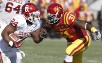 Running back Brennan Clay #24 of the Oklahoma Sooners rushes up field during the third quarter against defensive end Rony Nelson #31 of the Iowa State Cyclones on November 3, 2012 at Jack Trice Stadium in Ames, Iowa. Oklahoma defeated Iowa State 35-20. (Photo by Matthew Holst/Getty Images)