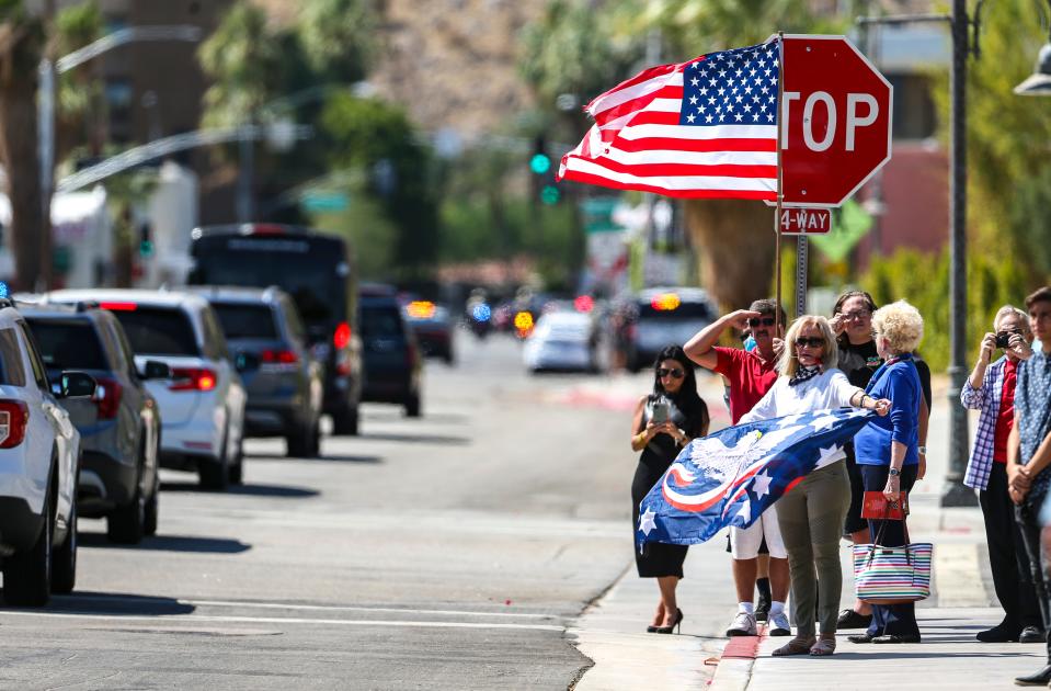 People watch as the procession transporting fallen Marine Cpl. Hunter Lopez leaves the Palm Springs Convention Center on Sept. 18, 2021.