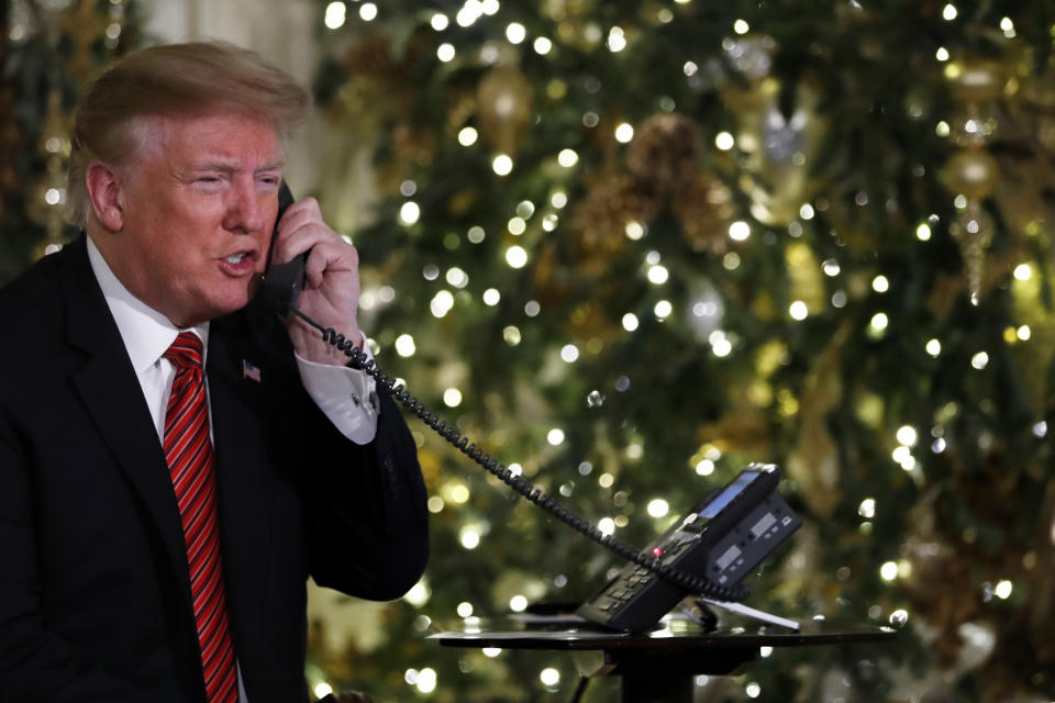 President Donald Trump speaks on the phone sharing updates to track Santa's movements from the North American Aerospace Defense Command (NORAD) Santa Tracker on Christmas Eve, Monday, Dec. 24, 2018. (AP Photo/Jacquelyn Martin)