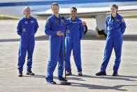 European Space Agency astronaut Matthias Maurer, of Germany, second from left, gestures as he speaks about fellow crew members, from left, NASA astronaut Tom Marshburn, Raja Chari, and Kayla Barron after arriving at the Kennedy Space Center in Cape Canaveral, Fla., Tuesday, Oct. 26, 2021. The mission, with a crew of four astronauts, will launch aboard a Crew Dragon spacecraft on SpaceX's Falcon 9 rocket from Kennedy's Launch Complex 39A early Sunday morning to the International Space Station. (AP Photo/John Raoux)