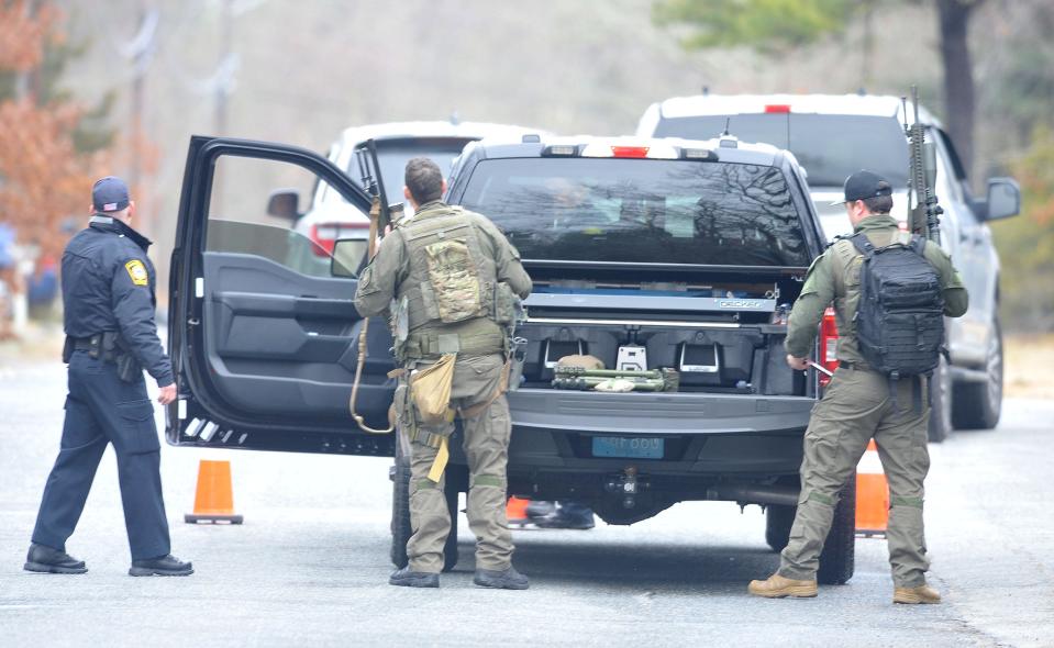 Barnstable Police officers look down St. John's Street towards its intersection with St. Francis Circle in Hyannis where a person is barricaded in a home. 
Steve Heaslip/Cape Cod Times