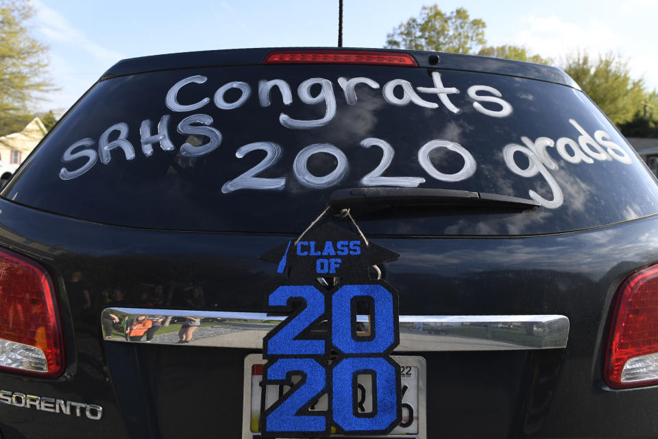 A car is decorated to celebrate the South River High School Class of 2020 during a family parade in Edgewater, Md., Monday, April 20, 2020. Many of the South River High School families found ways to celebrate their seniors given that prom, graduation and other traditional senior activities were canceled because of the coronavirus pandemic. (AP Photo/Susan Walsh)