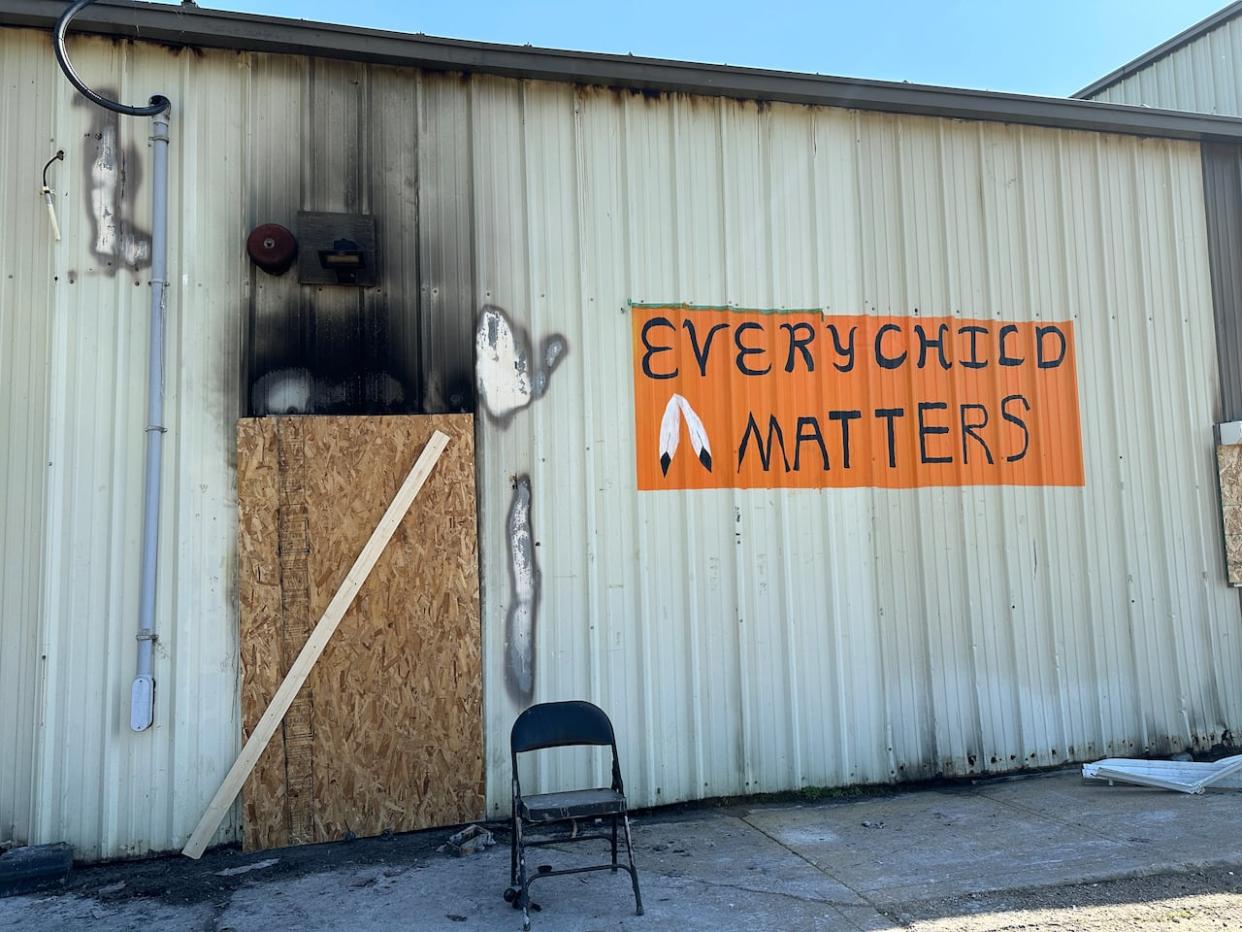 Doors to the fire-damaged Pigeon Lake Recreation Centre have been boarded up. (Madeleine Cummings/CBC - image credit)