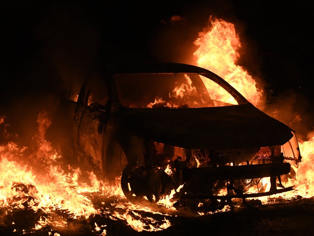 A burning car in Nanterre (EPA)