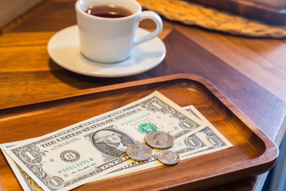 a few dollars and coins left on the table as a tip