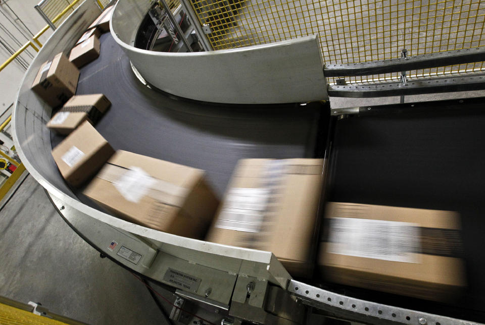 FILE - In this file photo dated Monday, Nov. 26, 2012, packages move along a conveyor belt ready to ship from the Amazon fulfillment center, in Phoenix, U.S.A. In the past year, the European Union’s executive Commission has opened a preliminary investigation into Amazon over concerns the e-commerce giant is using data to get an advantage over smaller third-party merchants on its platform. (AP Photo/Ross D. Franklin, FILE)