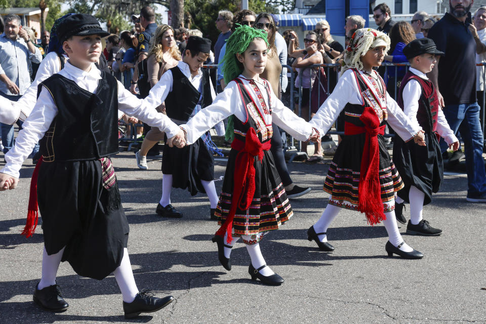 Children participate in a procession towards the spring bayou during the 118th annual celebration of Epiphany on Saturday, Jan. 6, 2024, in Tarpon Springs, Fla. (Jefferee Woo/Tampa Bay Times via AP)