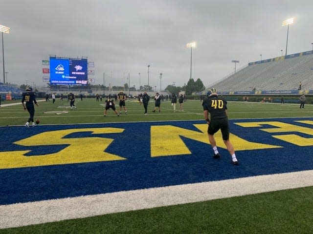 Delaware punter Ryan Kost gets his pregame work in with rain falling and the wind blowing at Delaware Stadium on Saturday, Sept. 23, 2023.