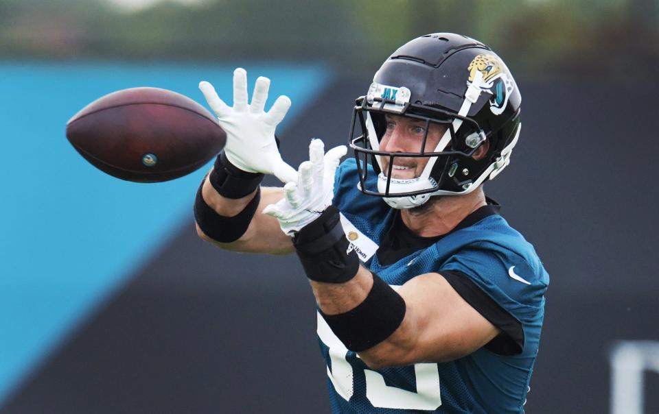 Jaguars DT (85) Tim Tebow pulls in a pass on the practice fields outside TIAA Bank Field during the Jacksonville Jaguars  mandatory veterans minicamp session Monday morning, June 14, 2021. [Bob Self/Florida Times-Union]