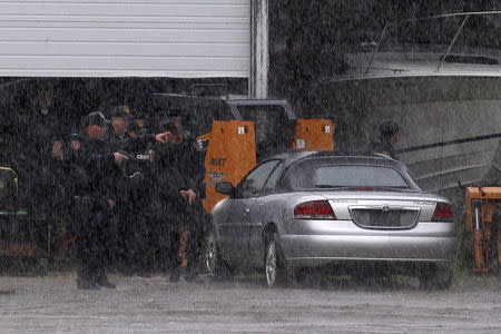 Law enforcement officers search a farm near Willsboro, New York, June 9, 2015. REUTERS/Chris Wattie