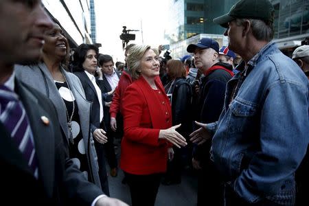 U.S. Democratic presidential candidate Hillary Clinton greets picketing Verizon workers who are out on strike in the Manhattan borough of New York April 13, 2016. REUTERS/Mike Segar