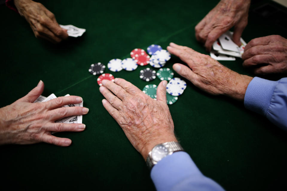 Retirees play poker at a singles club in Sun City, Arizona, January 4, 2013. Sun City was built in 1959 by entrepreneur Del Webb as America?s first active retirement community for the over-55's. Del Webb predicted that retirees would flock to a community where they were given more than just a house with a rocking chair in which to sit and wait to die. Today?s residents keep their minds and bodies active by socializing at over 120 clubs with activities such as square dancing, ceramics, roller skating, computers, cheerleading, racquetball and yoga. There are 38,500 residents in the community with an average age 72.4 years.    Picture taken January 4, 2013.   REUTERS/Lucy Nicholson (UNITED STATES - Tags: SOCIETY)    ATTENTION EDITORS - PICTURE 8 OF 30 FOR PACKAGE 'THE SPORTY SENIORS OF SUN CITY'  SEARCH 'SUN CITY' FOR ALL IMAGES