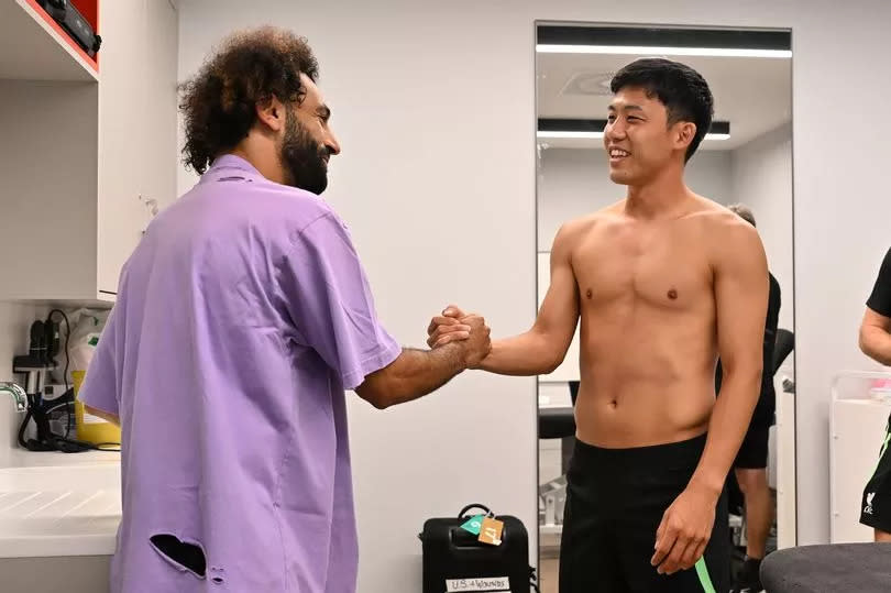 Wataru Endo new signing of Liverpool with Mohamed Salah of Liverpool at AXA Training Centre on August 18, 2023 in Kirkby, England.