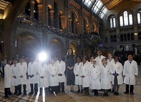 Britain's Catherine, Duchess of Cambridge poses with pupils from Oakington Manor Primary School, Wembley, in front of Dippy the Diplodocus, as she attends a children's tea party to celebrate Dippy's time in Hintze Hall at the Natural History Museum in London, Britain November 22, 2016. REUTERS/Yui Mok/Pool