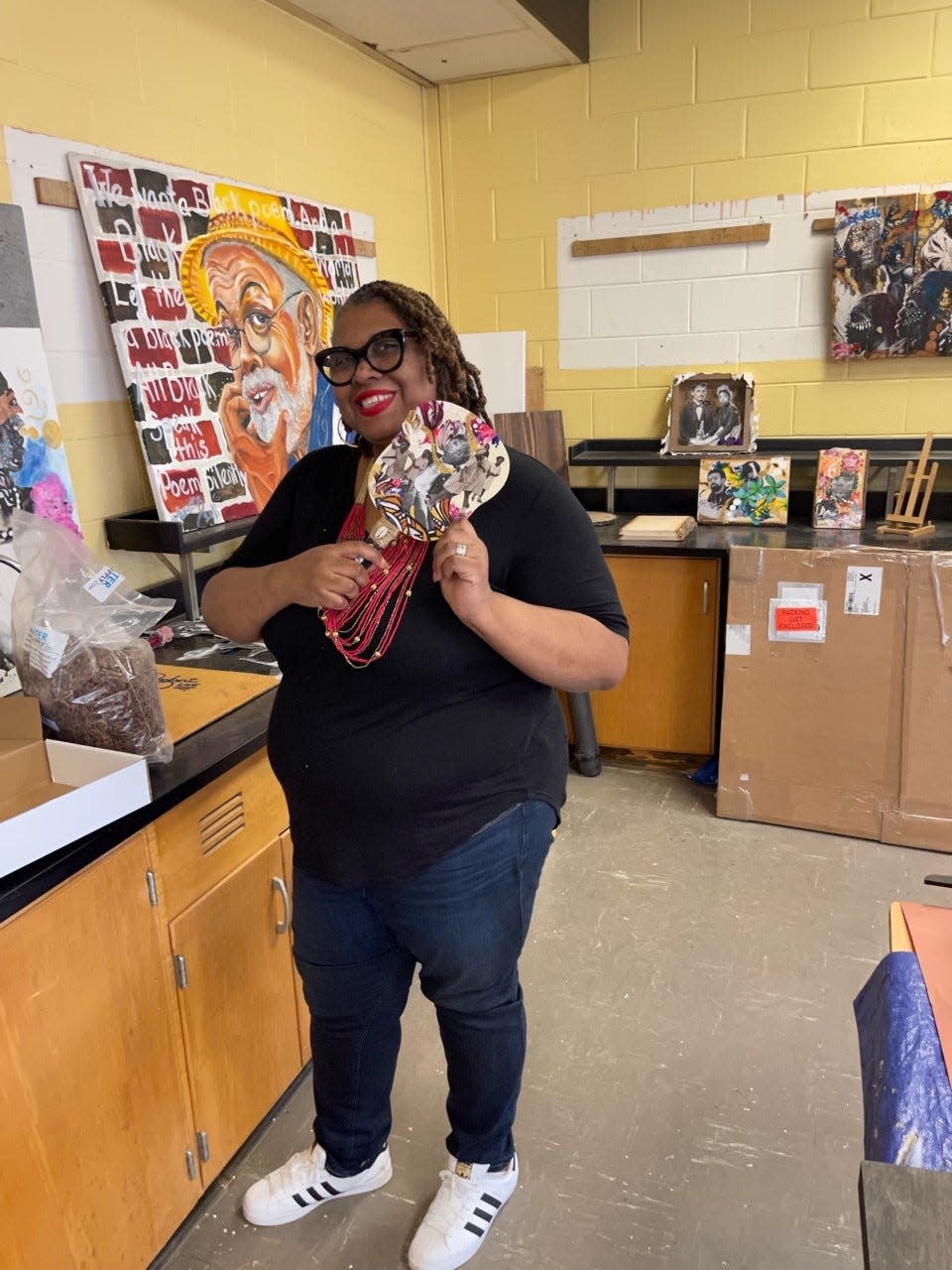 Artist Lavett Ballard is shown at Willingboro's Kennedy Center holding a fan she created and sold in a studio sale. Ballard's artwork was recently featured on the front of Time Magazine and inside as well.