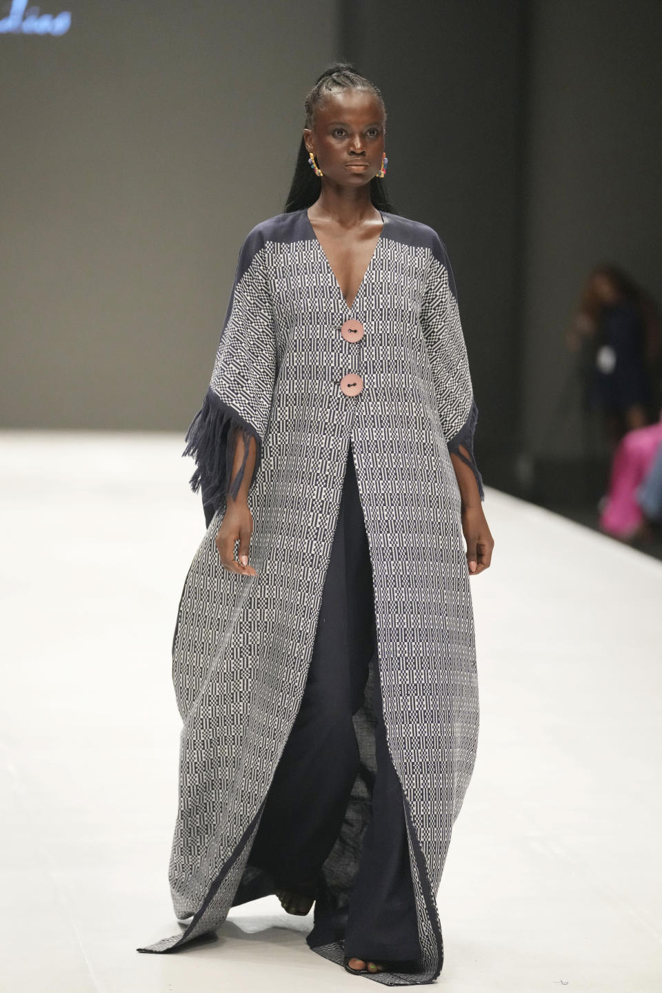 A model displays a creation by Cynthia Abila during the Lagos Fashion Week in Lagos, Nigeria, Thursday, Oct. 26, 2023. Africa's fashion industry is rapidly growing to meet local and international demands but a lack of adequate investment still limits its full potential, UNESCO said Thursday in its new report released at this year's Lagos Fashion Week show. (AP Photo/Sunday Alamba)