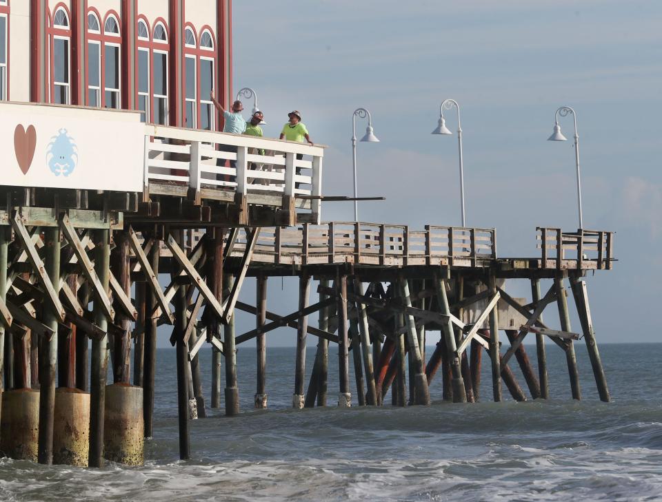 Workers survey the damage to the Daytona Beach Pier earlier this year. The iconic pier required more than $1.5 million in repairs after sustaining damage last fall during tropical storms Ian and Nicole.