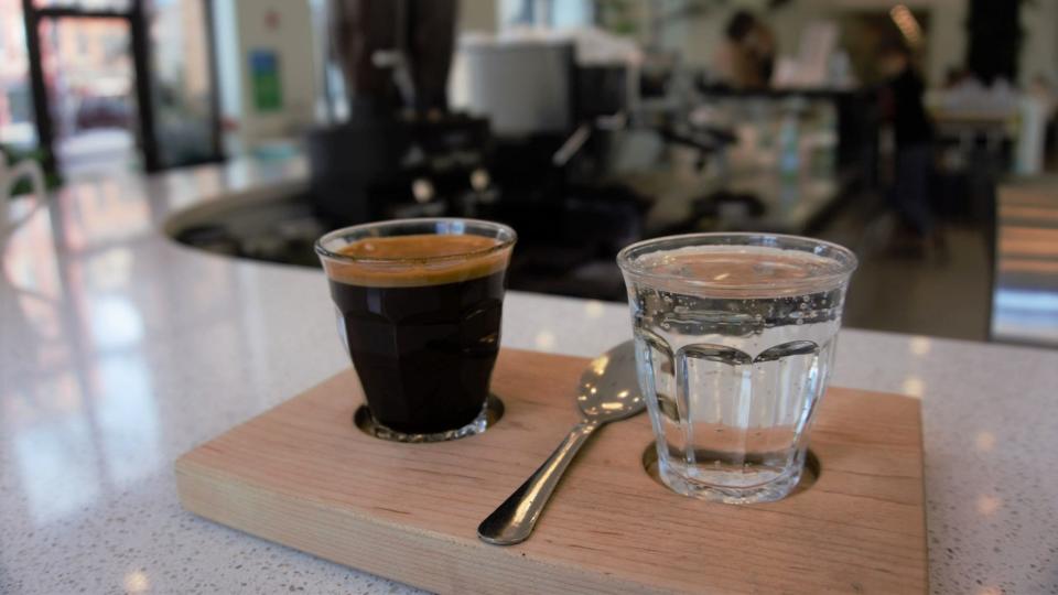 A double espresso is served with sparkling water at Prince St. Café in downtown York