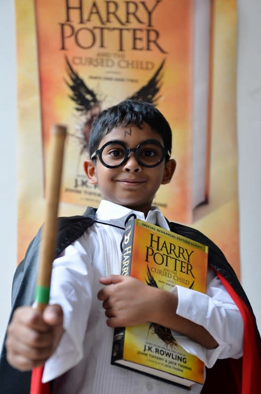 <p>An Indian fan of Harry Potter, dressed as the young wizard, poses for a photograph after picking up a copy of J.K. Rowling’s latest book “Harry Potter and the Cursed Child’ on the day of its launch at a book store, in Bangalore on July 31, 2016. </p>