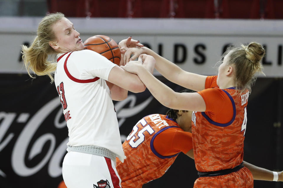 North Carolina State's Elissa Cunane (33) pulls a rebound from Clemson's Weronika Hipp (4) during the first half of an NCAA college basketball game at Reynolds Coliseum in Raleigh, N.C., Thursday, Feb. 11, 2021. (Ethan Hyman/The News & Observer via AP)