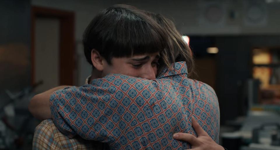 Will and Jonathan hugging in a pizzeria in "Stranger Things"