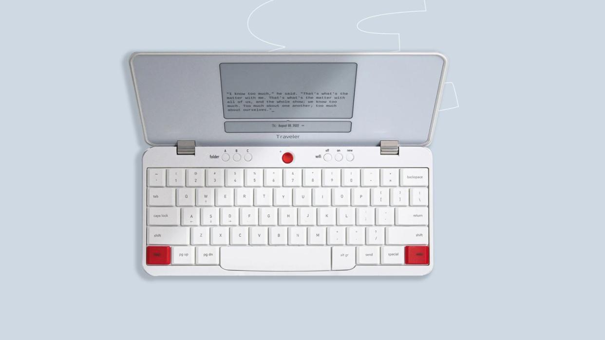 a white computer with a red button