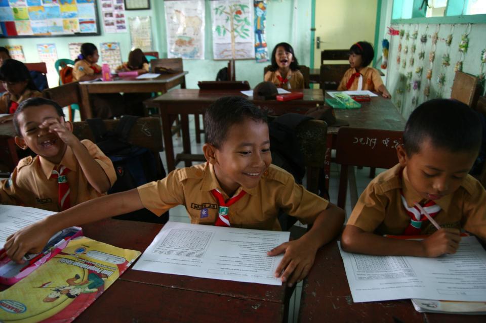 Indonesian student Wahyu (center), 8, during class on May 31, 2013. 