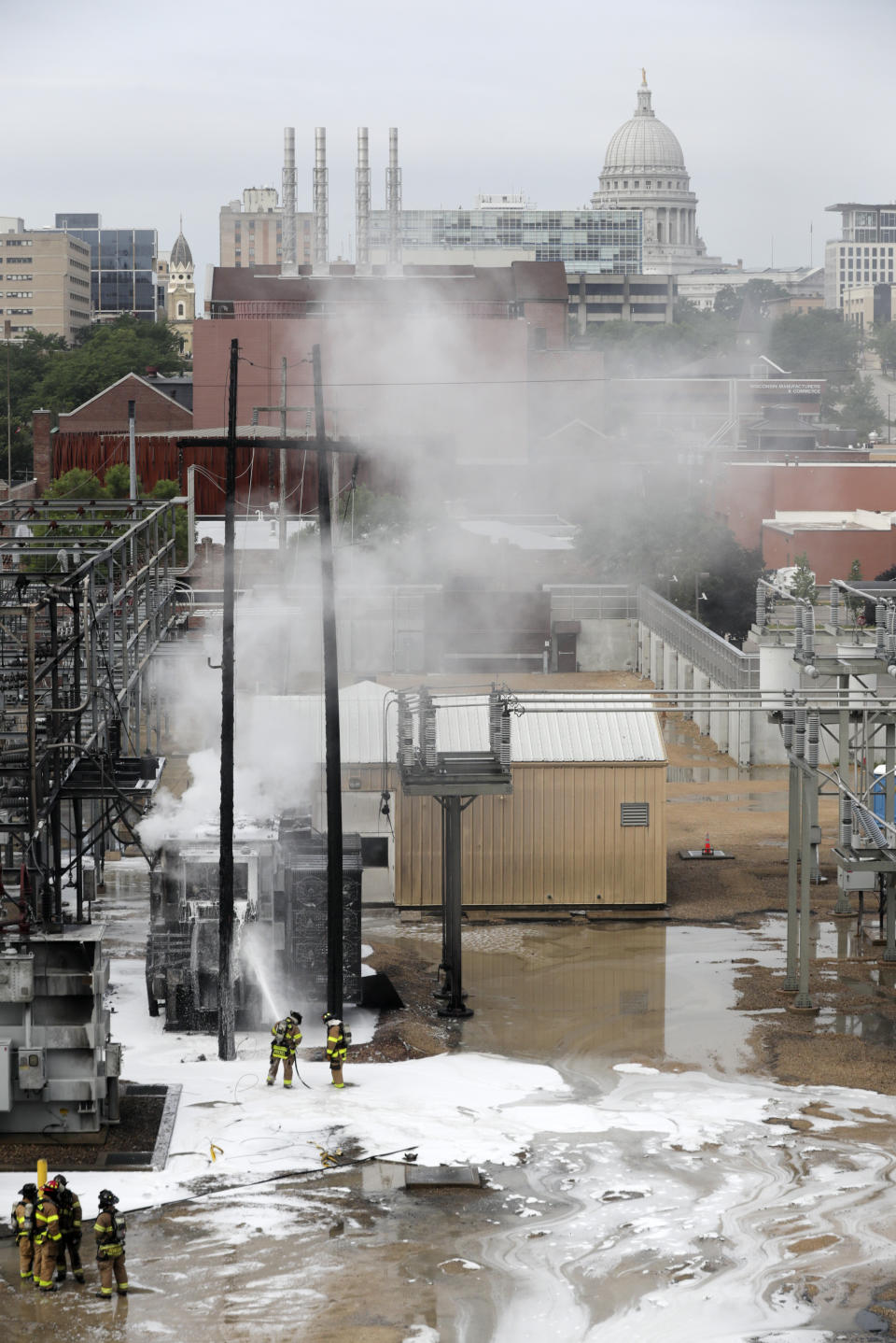 Madison Fire department respond at the scene of a fire at Madison Gas and Electric, Friday, July 19, 2019 in Madison, Wis. (Steve Apps/Wisconsin State Journal via AP)