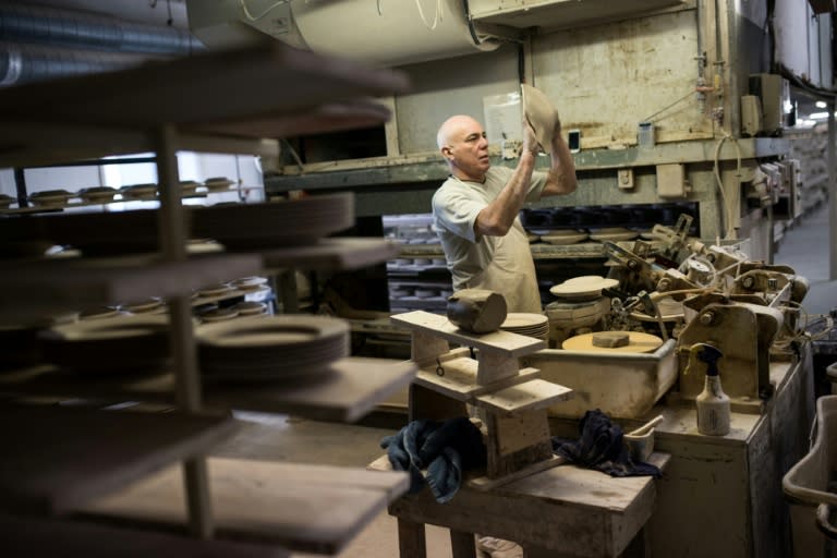 A worker produces crockery in the Emma Bridgewater factory, which employs around 185 people and manufactures 1.3 million pieces of pottery each year in the centre of Stoke-on-Trent