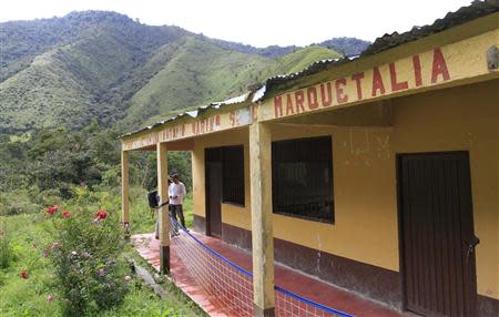 A man looks at school Marquetalia in the department of Tolima May 2, 2014. REUTERS/Jaime Saldarriaga