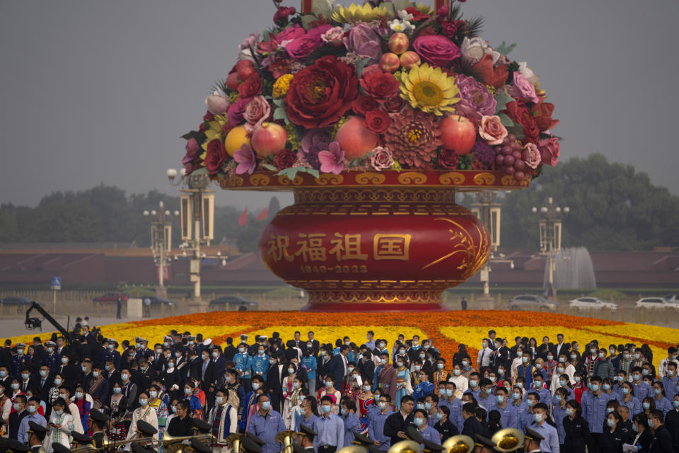 Participants stand before a ceremony to mark Martyr's Day at the Monument to the People's Heroes at Tiananmen Square in Beijing, Friday, Sept. 30, 2022. (AP Photo/Mark Schiefelbein)