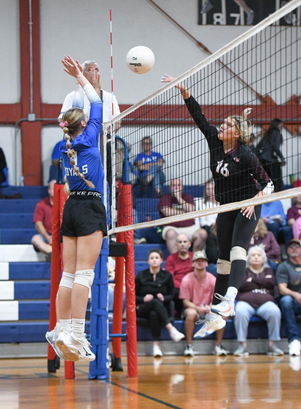 Darby Godwin (4) leaps to try to block the hit by Haley Westberry (16) during the Baker vs Jay 1-1A District Tournament championship volleyball match at Jay High School on Thursday, Oct. 19, 2023.