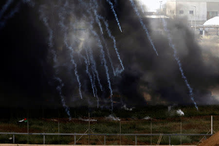 Israeli soldiers shoot tear gas from the Israeli side of the Israel-Gaza border, as Palestinians protest on the Gaza side of the border, Israel April 5, 2018. REUTERS/Amir Cohen