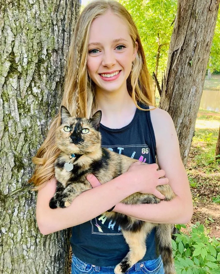 Photo of Emory Ivie holding her cat Stormy.