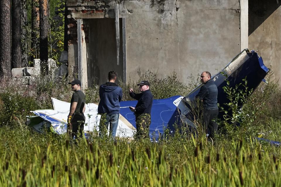 Russian investigators inspect a part of a crashed private jet near the village of Kuzhenkino, Tver region, Russia, Thursday, Aug. 24, 2023. Russia's mercenary chief Yevgeny Prigozhin's presumed death in a plane crash along with some of his top lieutenants raised questions about the future of his Wagner Group that has sent forces to African countries. (AP Photo/Alexander Zemlianichenko, File)