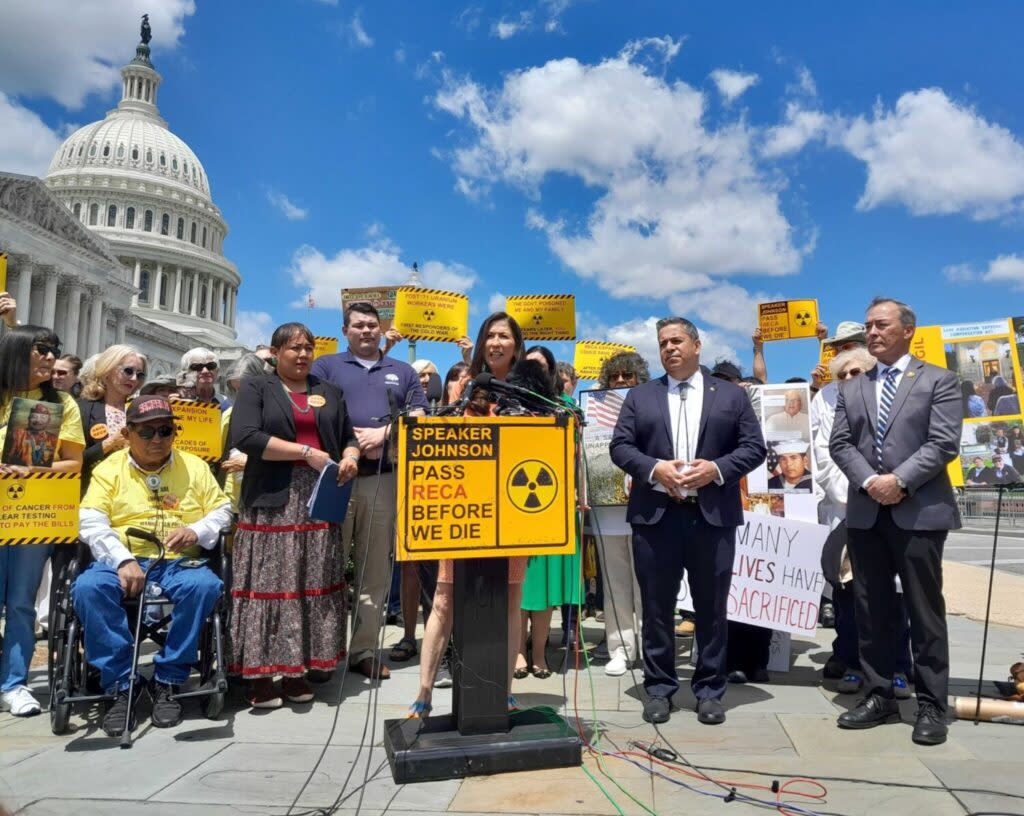 New Mexico Democrats Rep. Teresa Leger Fernandez, at the lectern, and Sen. Ben Ray Luján, and Guam’s Republican House delegate, James Moylan, along with advocates, on May 16, 2024, urged House Speaker Mike Johnson to call a vote to extend the Radiation Exposure Compensation Fund. (Ashley Murray/States Newsroom)