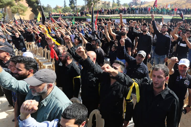 Supporters of Lebanon's Hezbollah leader Sayyed Hassan Nasrallah gesture as they listen to his televised speech in Baalbeck