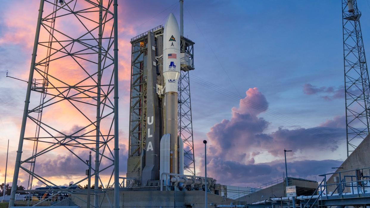  a large white rocket on a launch pad at sunrise 