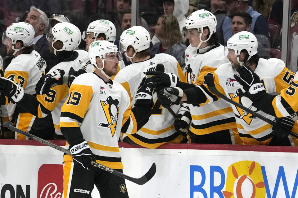 Pittsburgh Penguins right wing Reilly Smith (19) is congratulated after scoring a goal during the second period of an NHL hockey game against the Florida Panthers, Friday, Dec. 8, 2023, in Sunrise, Fla. (AP Photo/Lynne Sladky)