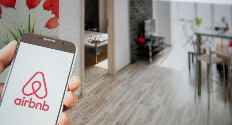 AirBnB phone app shown inside home.