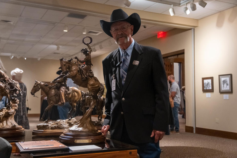 Arizona artist Bill Nebeker stands with his award winning bronze sculpture "Waltzing Across Texas" at the 15th annual AQHA Art Show Aug. 12 in Amarillo.