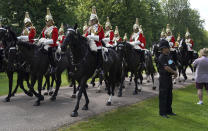 Members of the Household Cavalry make their way along the Long Walk towards Windsor Castle, Windsor, England, Saturday June 12, 2021, ahead of a ceremony to mark the official birthday of Queen Elizabeth II. (Andrew Matthews/PA via AP)