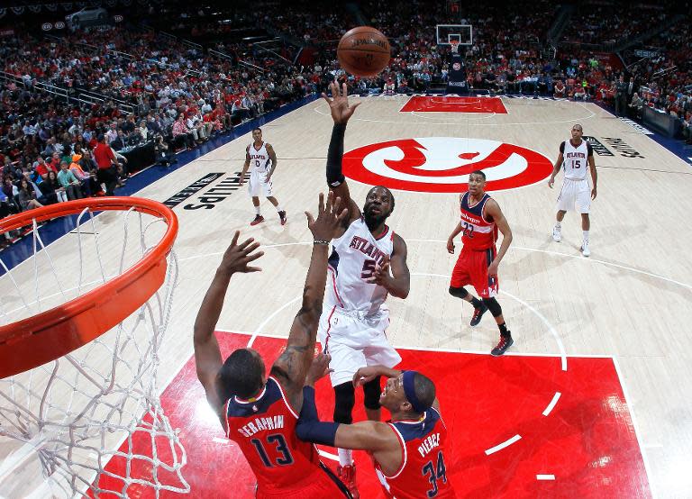 Atlanta Hawks' DeMarre Carroll shoots over Washington Wizards' Kevin Seraphin and Paul Pierce during Game Two of the Eastern Conference semi-finals at Philips Arena on May 5, 2015