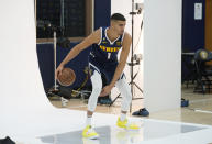 Denver Nuggets forward Michael Porter Jr. dribbles the ball during the NBA basketball team's Media Day, Monday, Sept. 26, 2022, in Denver. (AP Photo/David Zalubowski)