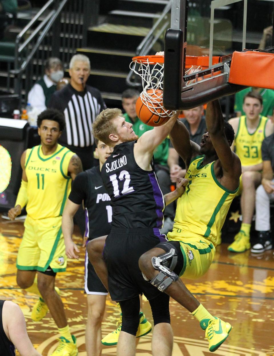 Oregon center N’Faly Dante dunks over a defender during Wednesday’s men’s basketball game against Portland at Matthew Knight Arena.