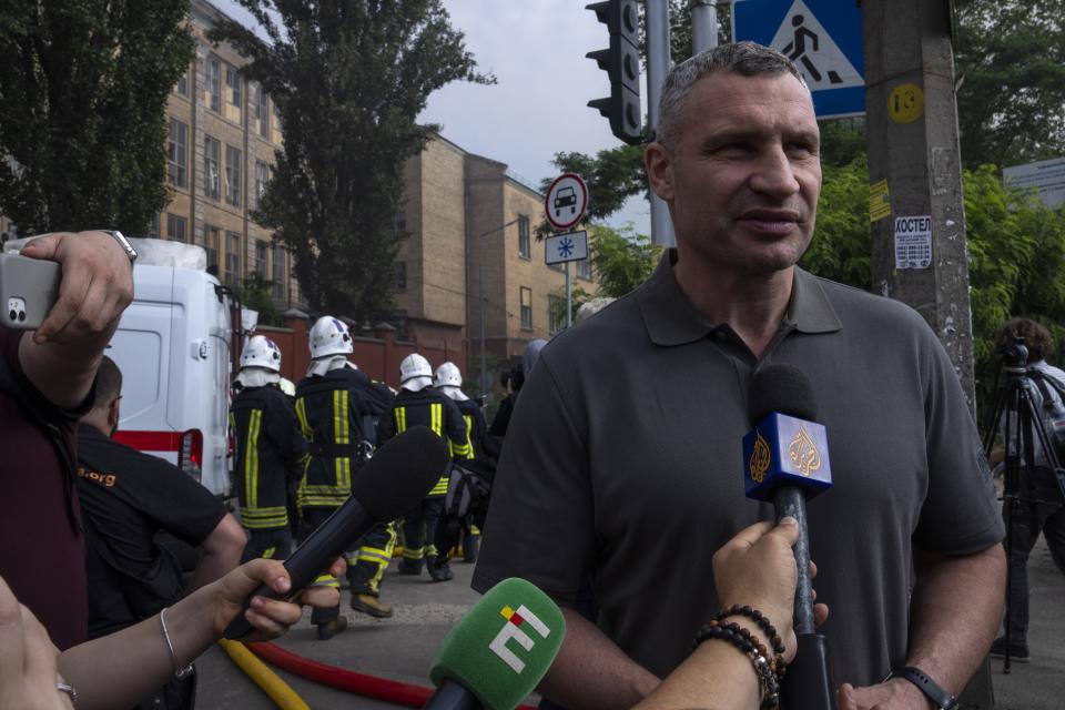 FILE - Kyiv mayor Vitali Klitschko speaks to the press at the scene of a residential building following explosions, in Kyiv, Ukraine, on June 26, 2022. "Each day of the war means destroyed villages and cities in Ukraine, and the crippled fates of our colleagues," Klitschko said. As Russians seized parts of eastern and southern Ukraine in the 8-month-old war, mayors, civilian administrators and others, including nuclear power plant workers, say they have been abducted, threatened or beaten to force their cooperation. In some instances, they have been killed. Human rights activists say these actions could constitute a war crime. (AP Photo/Nariman El-Mofty, File)