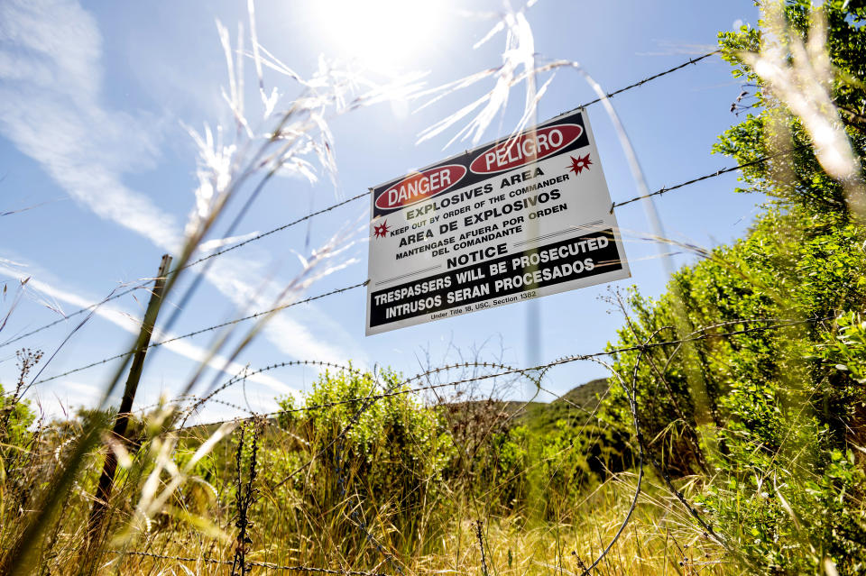 A sign warns Fort Ord visitors to stay out of an area that may contain unexploded ordinance on Thursday, April 29, 2021, in Fort Ord, Calif. Among the dozens of pollutants that scientists discovered as early as 1985 was the solvent trichloroethylene, or TCE, a caustic chemical that today still exists in concentrations above the legal limit for drinking water in the aquifer. (AP Photo/Noah Berger)