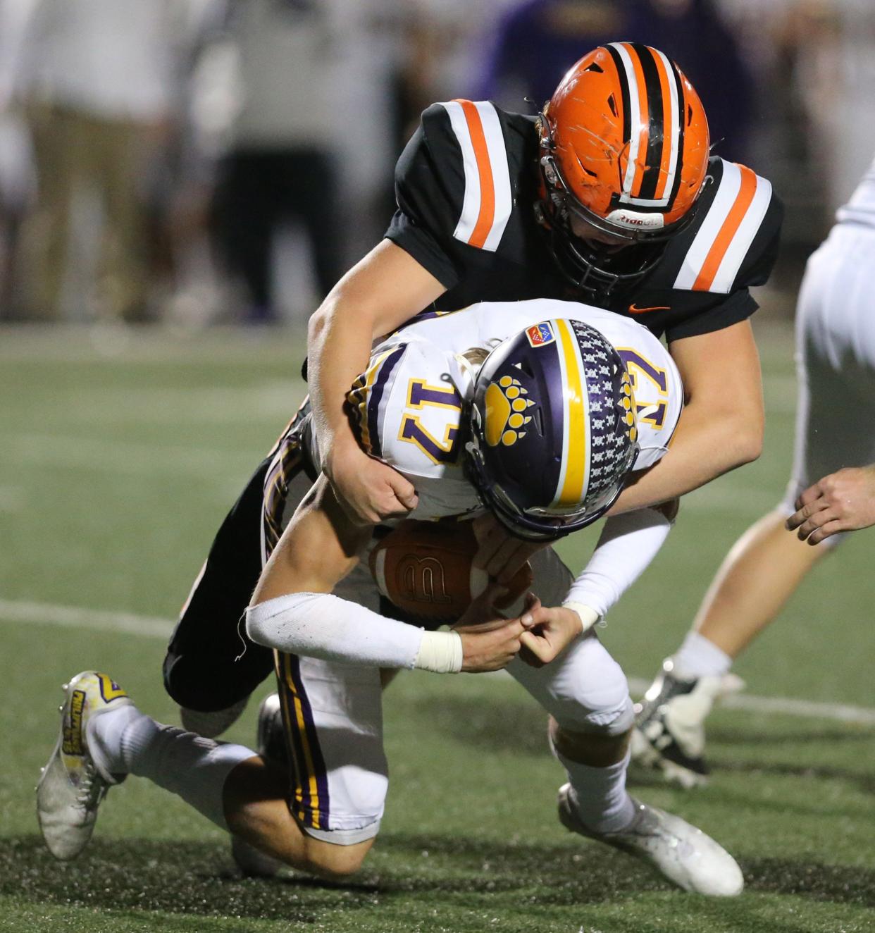 Hunter Geissinger, 17, of Jackson is sacked by Drew Logan, rear, of Hoover during their game at Hoover on Friday, Oct. 22, 2021. 